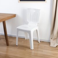 a white plastic chair next to a table