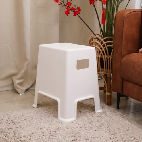 a white stool on a rug